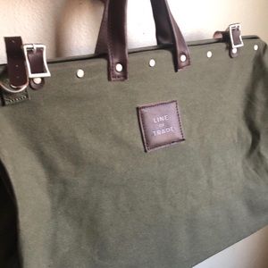 Line of trade dark green canvas weekender bag.